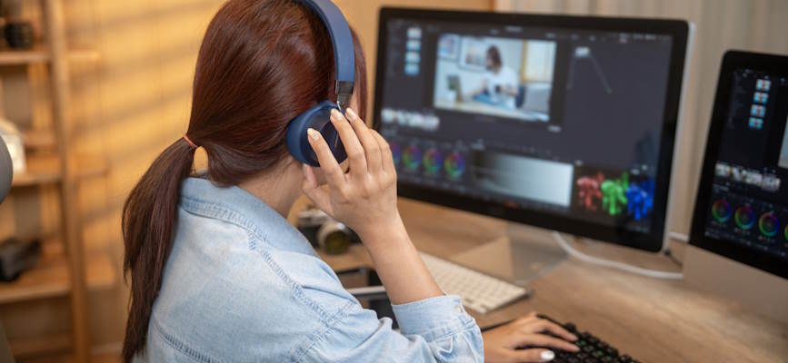 -woman editing digital video to show investment-