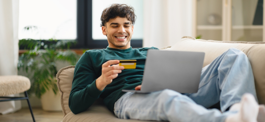 __Happy man paying for streaming subscription __