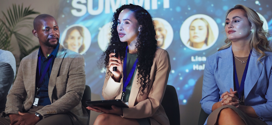 Speakers on stage at a Summit to represent live events in the media business